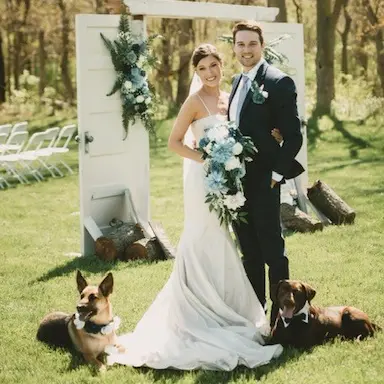 Megan and her husband with their two dogs.